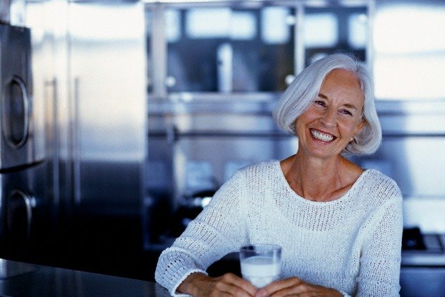 Middle-aged Woman Having Glass of Milk Menopoz